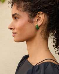profile view of Haro wearing the emerald le hoop earrings 