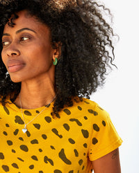 mecca wearing the emerald le hoop earrings  with a marigold tshirt 