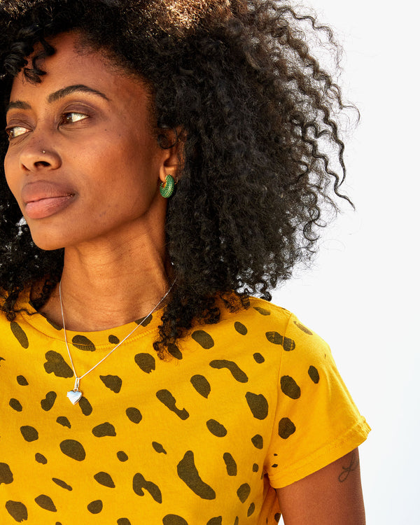 mecca wearing the emerald le hoop earrings  with a marigold tshirt 