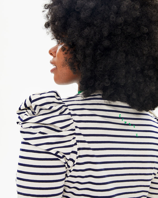 close up view of the puff sleeves on the Le Puff Dress in Navy & Cream Stripe worn by Candice