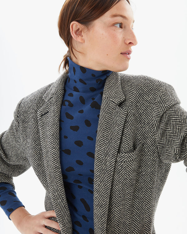 Zoe wearing the Faded Marine Jaguar Le Turtleneck with a blazer