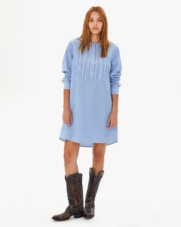Aurelia wearing the Blue & Cream Stripe Le Tux Dress standing facing the camera with cowboy boots