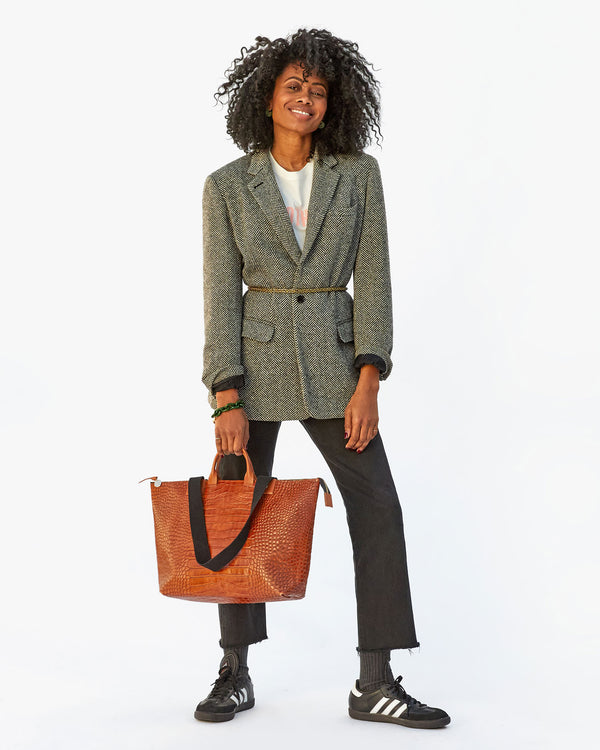 Mecca holding the Cuoio Croco Le Zip Sac by its top handle