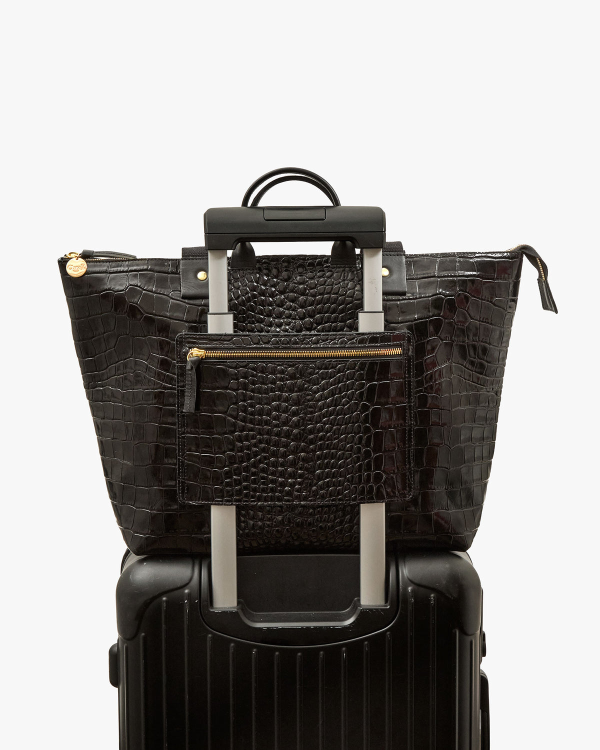 Le Zip Sac with Travel Pocket shown on roller suitcase handle
