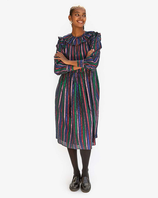 Jordan with her arms crossed in the Multi Stripe Léonie Dress