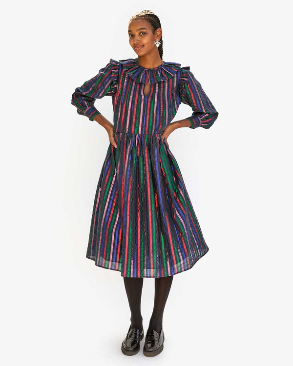 Jordan with her hands on her hips in the Multi Stripe Léonie Dress