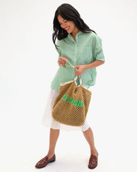 Full view of Lete Tote being held by the shoulder straps