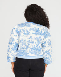 back view of candice in the Lilou Jacket St. Calais Blue Toile with black jeans