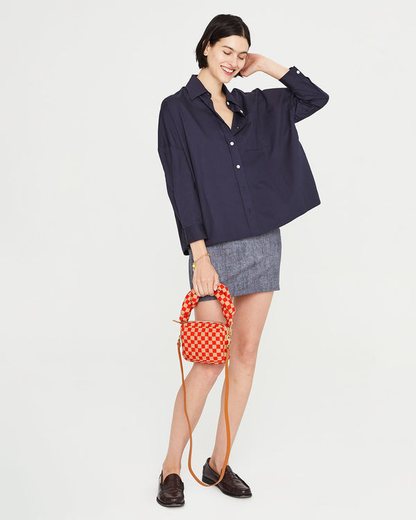 Athena holding the Poppy & Khaki Quilted Checker Lucie by its top handle