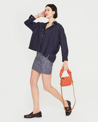 athena taking a step while carrying the Poppy & Khaki Quilted Checker Lucie