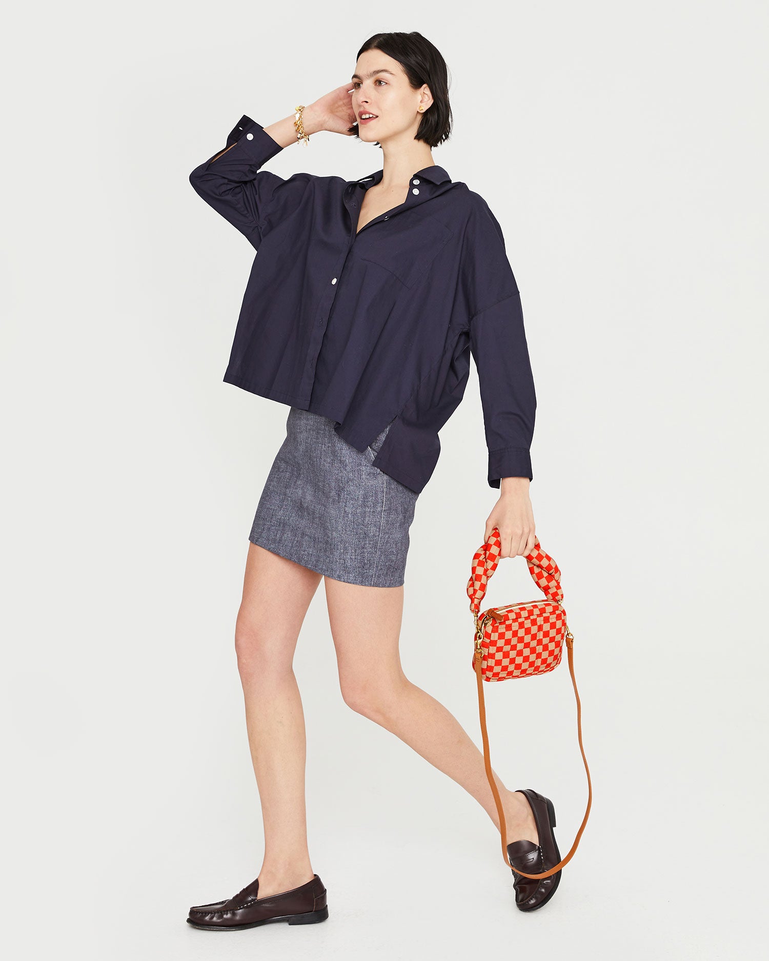 athena taking a step while carrying the Poppy & Khaki Quilted Checker Lucie