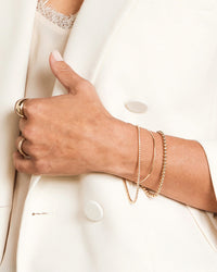 model wearing the Maya Brenner Off The Cuff Bracelet with various other barcelets