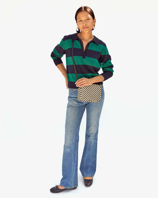 Maly wearing the Black & Cream Woven Zig Zag Midi Sac crossbody with jeans and a polo sweater