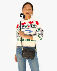 Maly wears the black zig zag woven midi sac as a crossbody