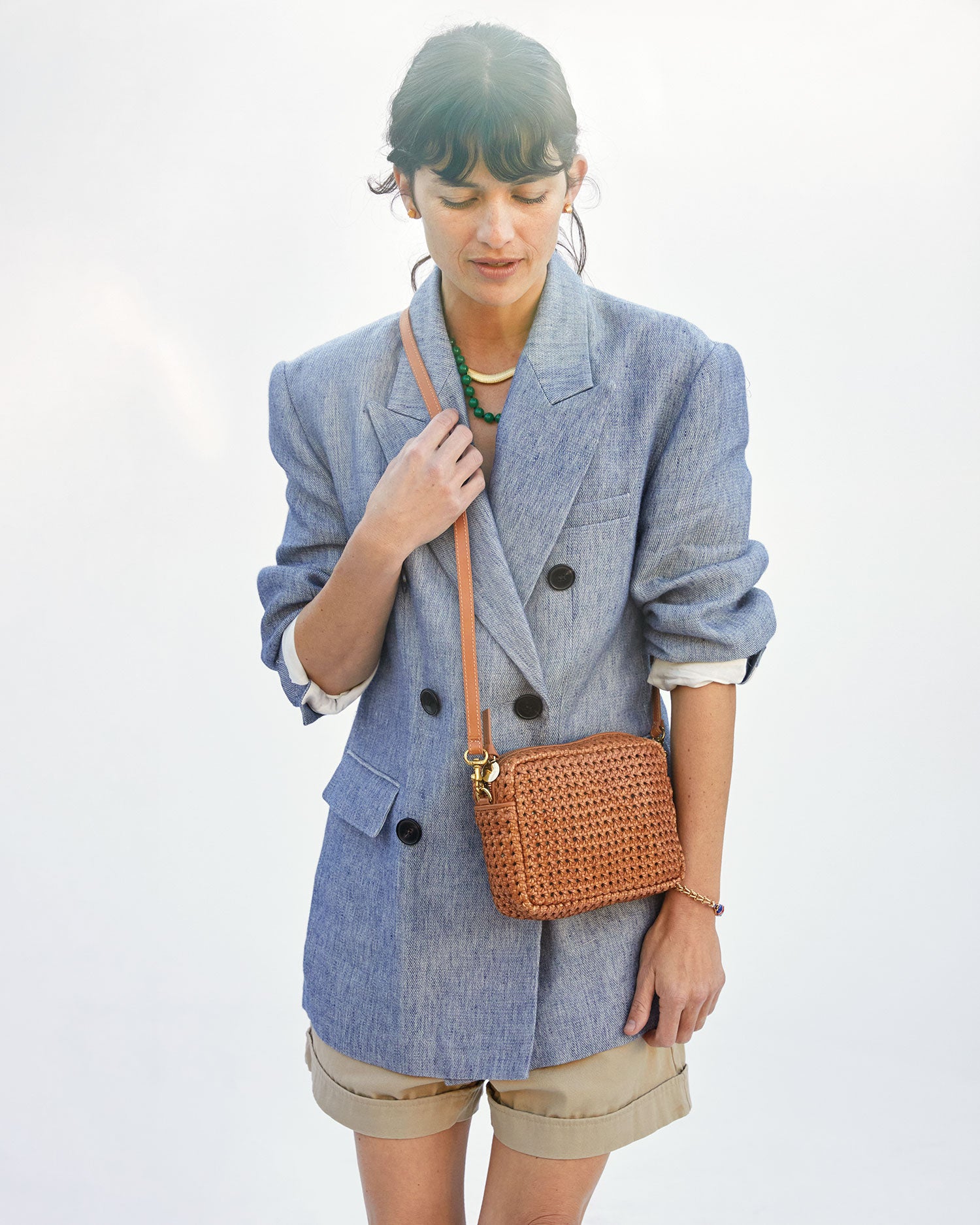 Danica is wearing the Midi Sac in Tan Rattan