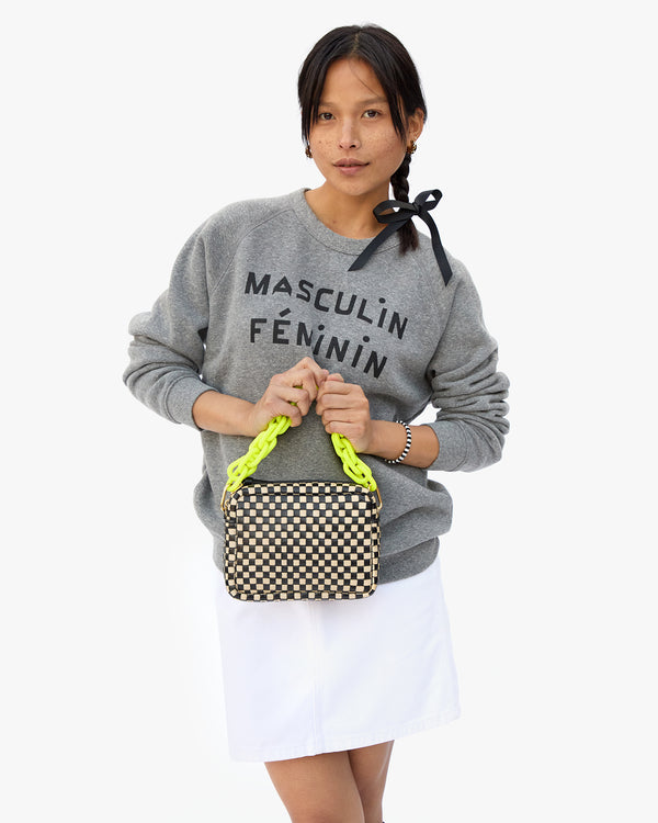 Maly Carrying the Black and Cream Woven Checker Midi Sac with the Neon Yellow Resin Shortie Strap 