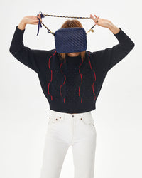 Aurelia holding the Pacific Woven Zig Zag Midi Sac in front of her face