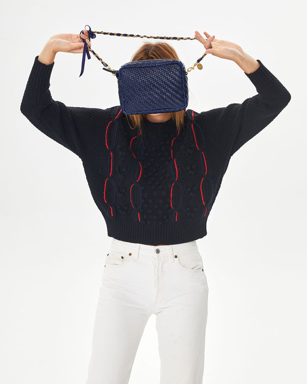 Aurelia holding the Pacific Woven Zig Zag Midi Sac in front of her face