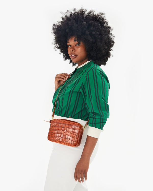 Candice showing where the Cuoio Autumn Croco Midi Sac falls on her body when worn as a crossbody bag - it falls on her hip. 