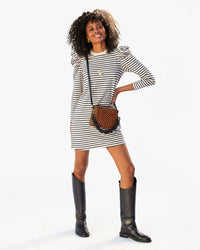 mecca wearing the Black & Natural Woven Checker Midi Sac crossbody with the black resin shortie strap attached to it 