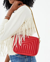 close up of the Rouge Channel Quilted Midi Sac on Mecca's shoulder. she's wearing the dream le drop fringe 
