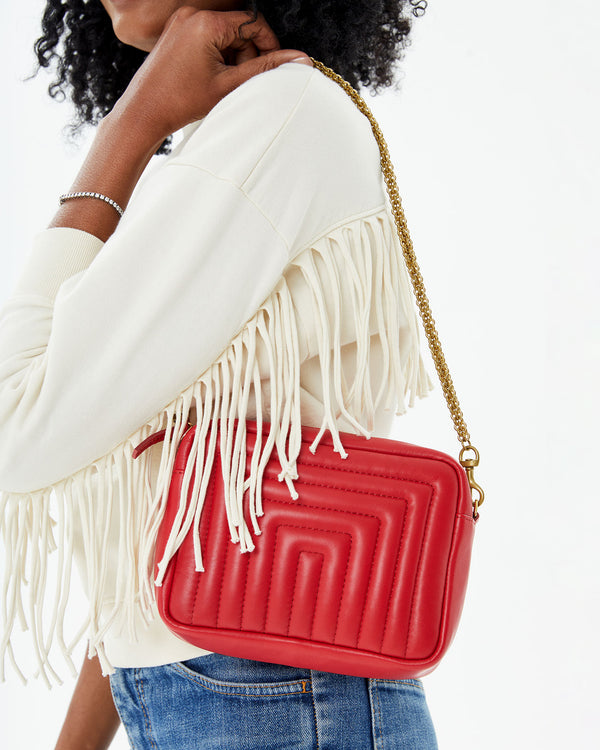 close up of the Rouge Channel Quilted Midi Sac on Mecca's shoulder. she's wearing the dream le drop fringe 