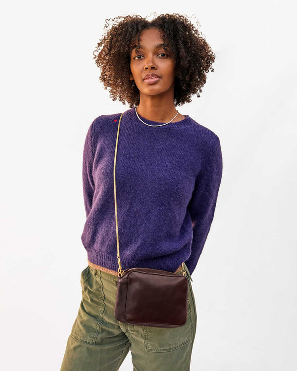 Jordan wearing the Kalamata Glacee MIdi Sac crossbody over the Sea Urchin Elsa Sweater.