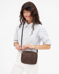 Model wearing the  Black/Chocolate Woven Checker Midi Sac crossbody.