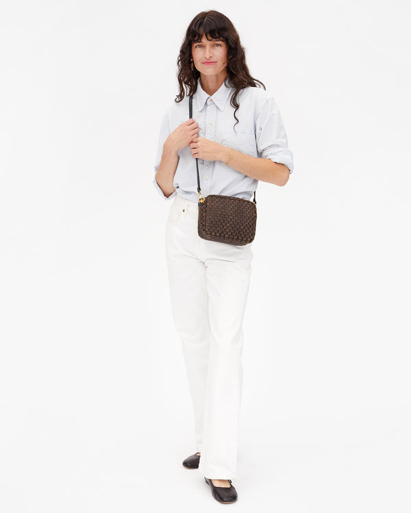 Full view of model wearing the Black/Chocolate Woven Checker Midi Sac crossbody. 