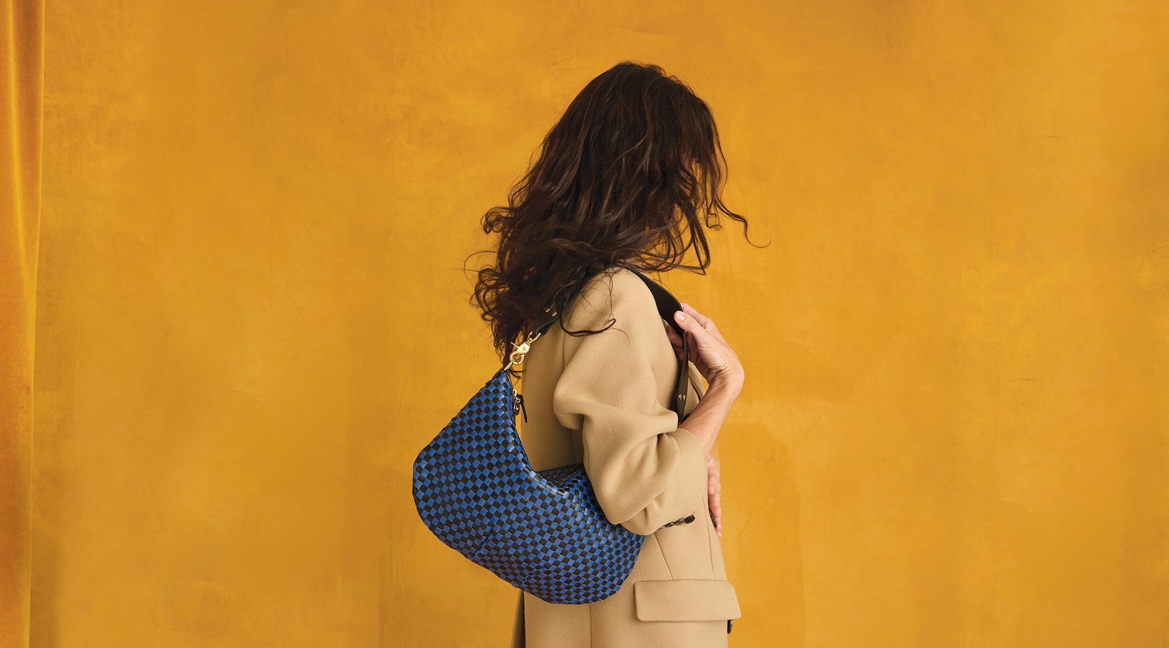 Model carrying the Black/Cobalt Moyen Messenger over her shoulder.