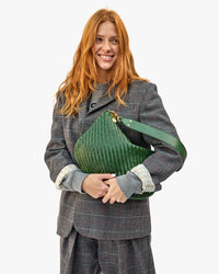 Haley Holding the Evergreen Woven Zig-Zag Moyen Messenger in her arms