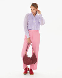 Aurelia holds the Oxblood Diagonal Woven Moyen Messenger in one hand