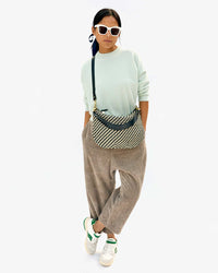 Maly wearing the Black & Cream Woven Zig Zag Moyen Messenger crossbody 