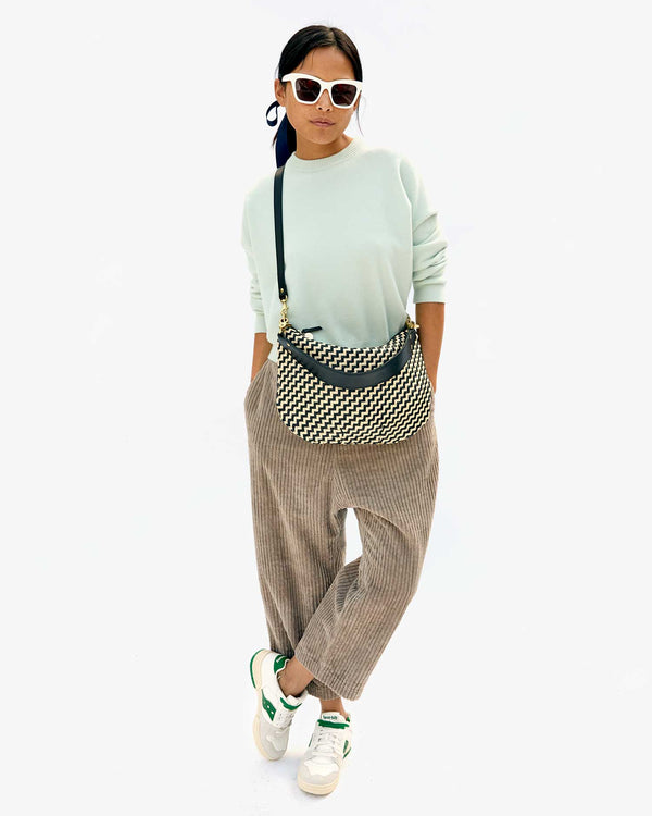 Maly wearing the Black & Cream Woven Zig Zag Moyen Messenger crossbody 