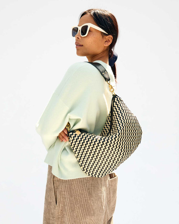 Maly with the Black & Cream Woven Zig Zag Moyen Messenger on her shoulder