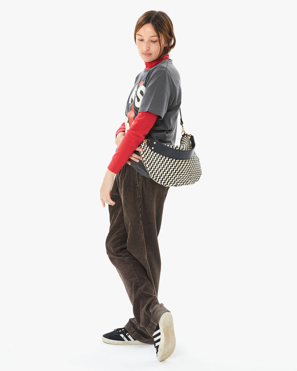 Zoe wearing the Black & Cream Woven Zig Zag Moyen Messenger crossbody 