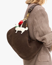 Close up view of Moyen Messenger in Chocolate Suede worn on the shoulder