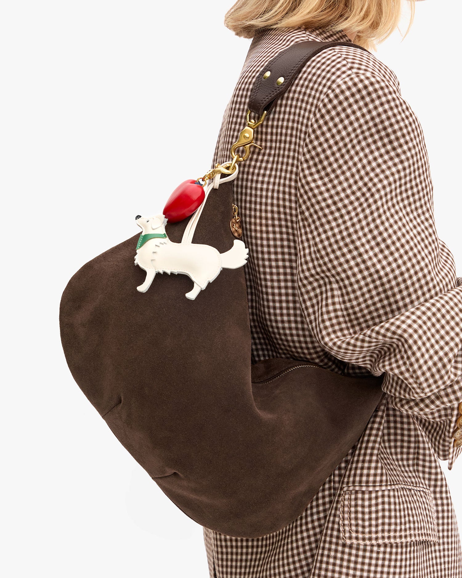 Close up view of Moyen Messenger in Chocolate Suede worn on the shoulder