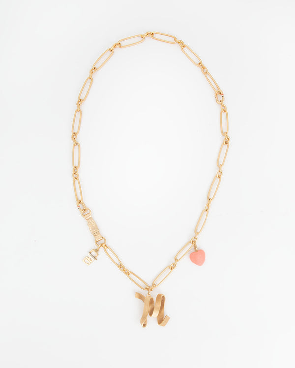 Convertible Chain Necklace Shown as a long necklace with the Ciao Charm, M Ribbon Letter Charm and Coral Stone Heart Charm
