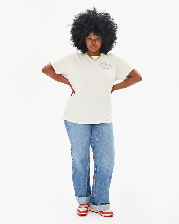 Candice wearing the Cream Bourgouise Sauvage Original Tee with jeans and sneakers