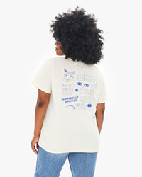 back view of Candice in the Cream Bourgouise Sauvage Original Tee worn with jeans