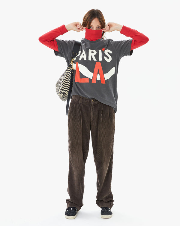 Zoe wearing the Faded Black Paris L.A. Original Tee over a red turtleneck with brown cords