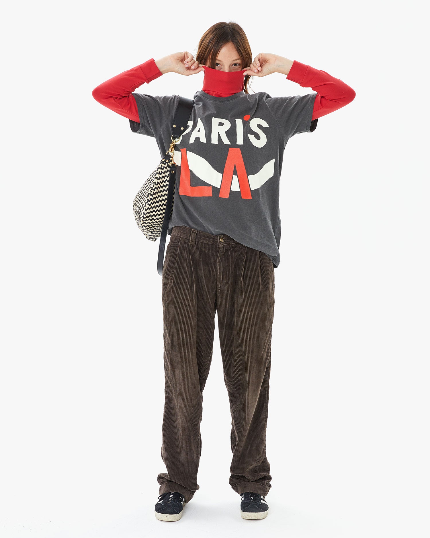 Zoe wearing the Faded Black Paris L.A. Original Tee over a red turtleneck with brown cords