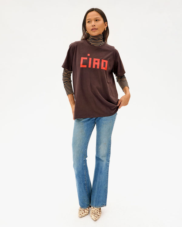 Maly wearing the Cocoa Ciao Original Tee with jeans over a striped turtleneck