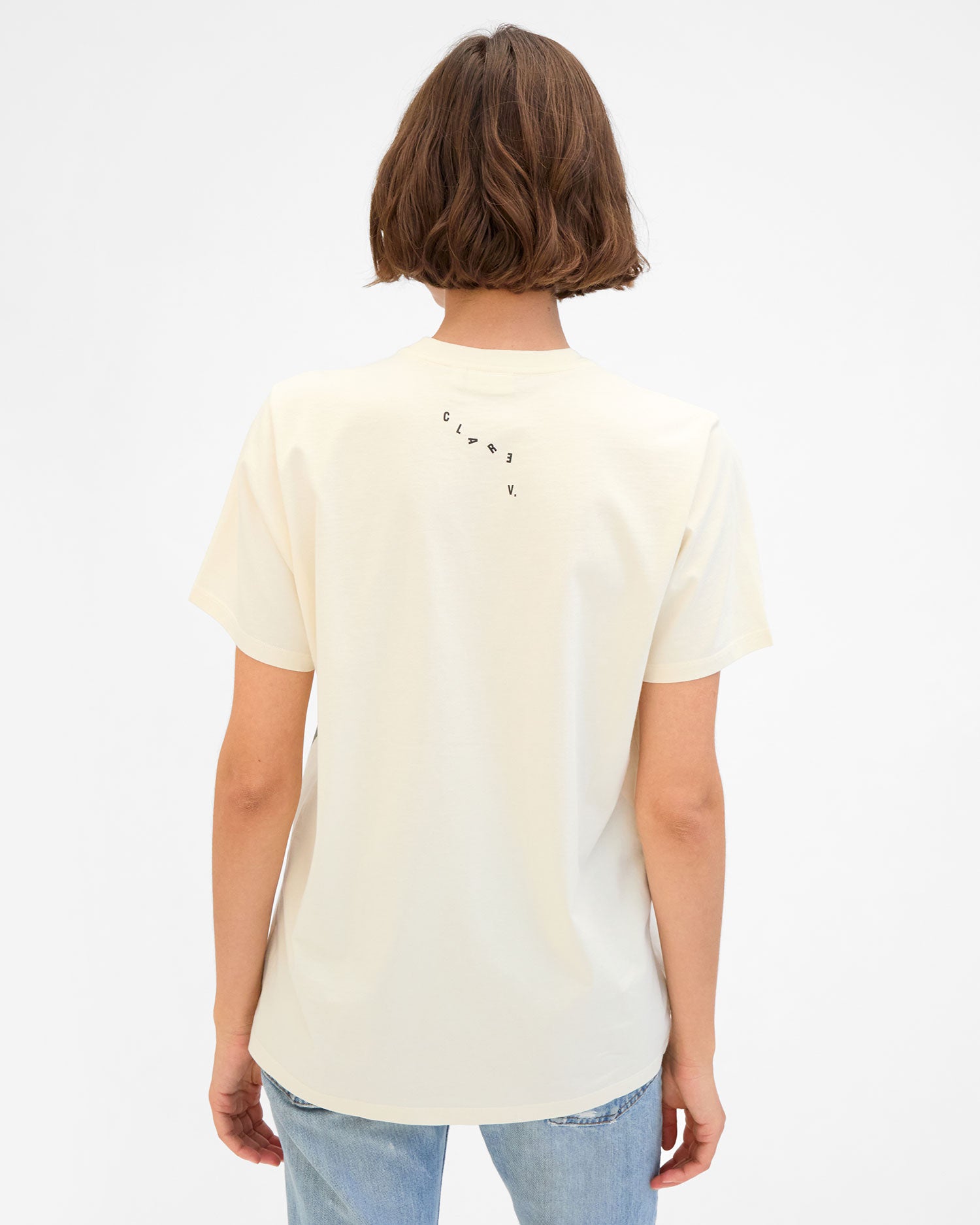 Back View of Kathie in the Cream Thierry Palm Original Tee