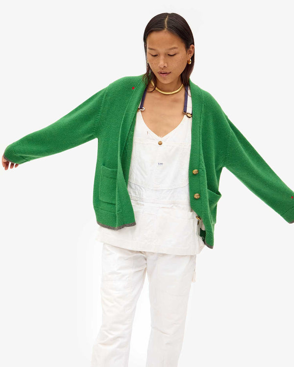Maly in white overalls with the Oscar Sweater in Granny Smith on