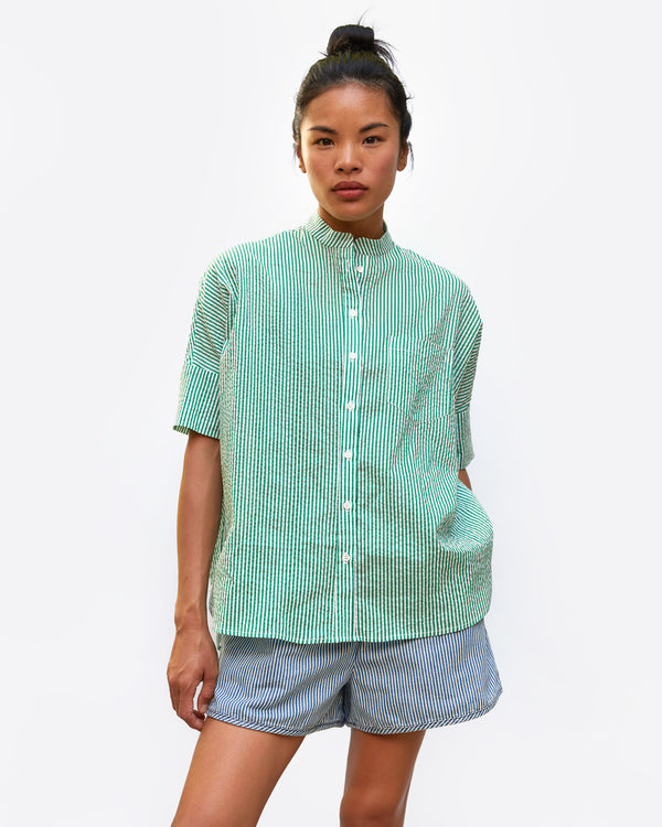 sandra wearing the Oversized Stand Collar Shirt in Green and Cream Stripe with her hand in the pocket of her shorts