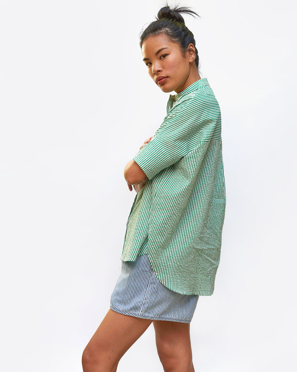 side view of sandra in the Oversized Stand Collar Shirt in Green and Cream Stripe