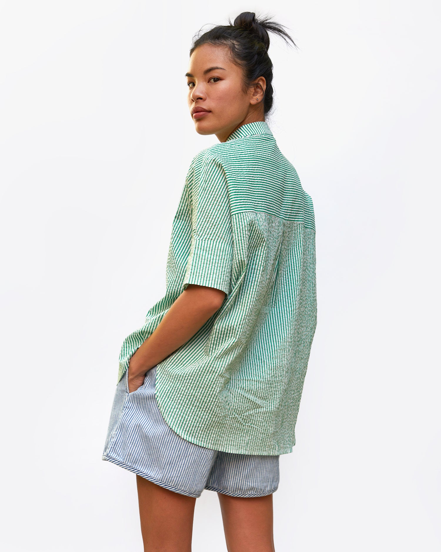 back view of sandra in the Oversized Stand Collar Shirt in Green and Cream Stripe