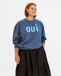 Sonnie wearing the faded Navy OUi Oversized Sweatshirt with a black tiered skirt